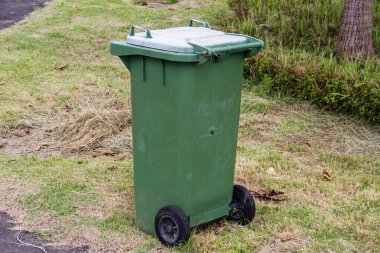 parkta yeşil çöp kovası