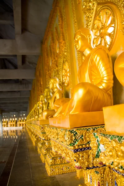 Row of golden monk buddhist statues — Stock Photo, Image