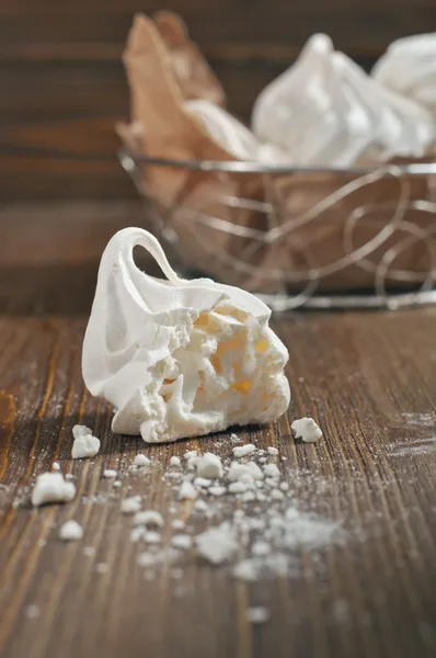 Broken meringue on wooden background — Stock Photo, Image