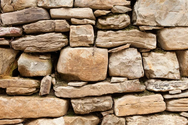 Of rough stone wall of big and small rocks Stock Photo
