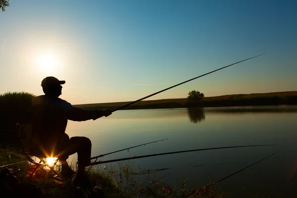 Young man fishing on a lake — Stock Photo, Image