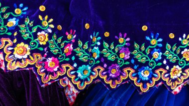 Close up of the skirt with traditional design for Cuenca city and Azuay province of Ecuador. It embroidered with silk thread and adorned with sequins and beads.