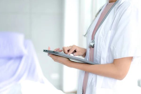 Telemedicine concept.  Hands doctor using tablet computer. Doctor online virtual consultation, chatting to patient, video call, virtual appointment on app.