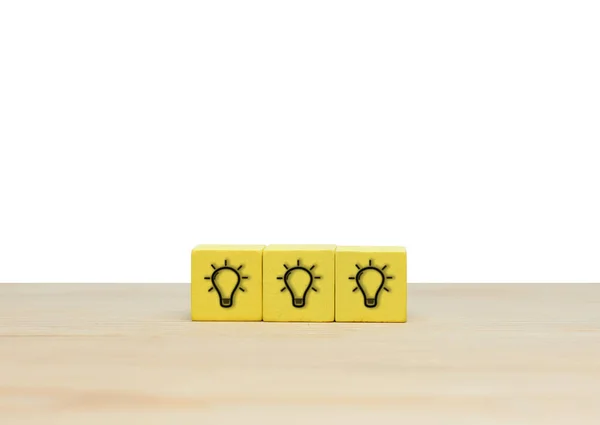 Creativity and innovation, light bulb icon on wooden cubes for idea concept