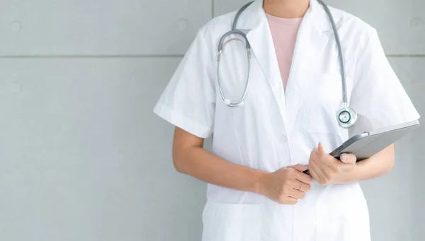 Telemedicine concept.  Hands doctor using tablet computer. Doctor online virtual consultation, chatting to patient, video call, virtual appointment on app.