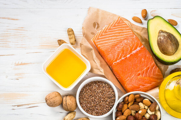 Healthy fats products at black background.