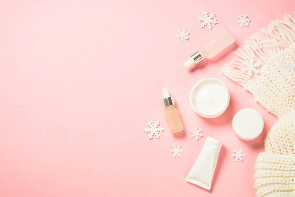 Winter cosmetic, skin care producton pink background. — Stock Photo, Image