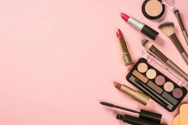 Make up products at pink background top view. — Stock fotografie