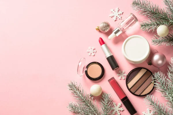 Make up products and christmas decorations at pink. — Stock Photo, Image