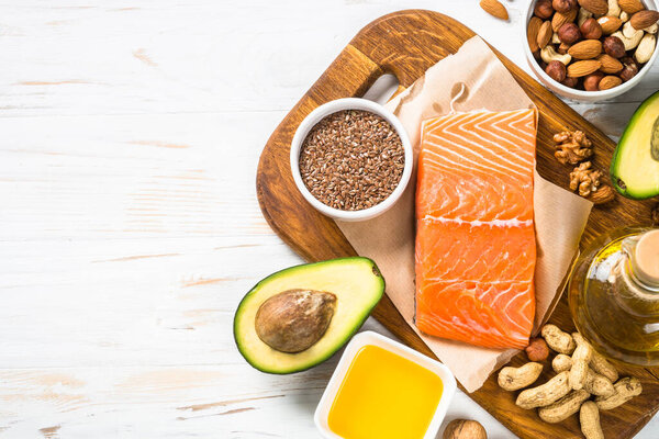 Healthy fats products at black background.