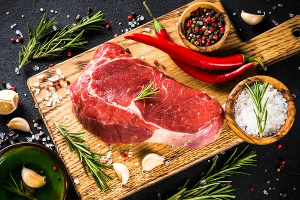 Raw beef steak with herbs. — Stock Photo, Image