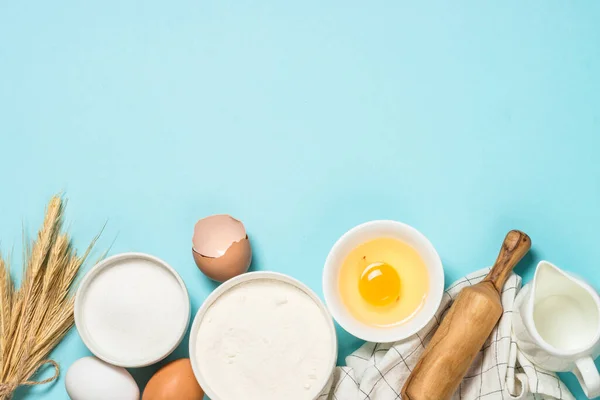 Baking ingredients at blue table top view. — Stock Photo, Image