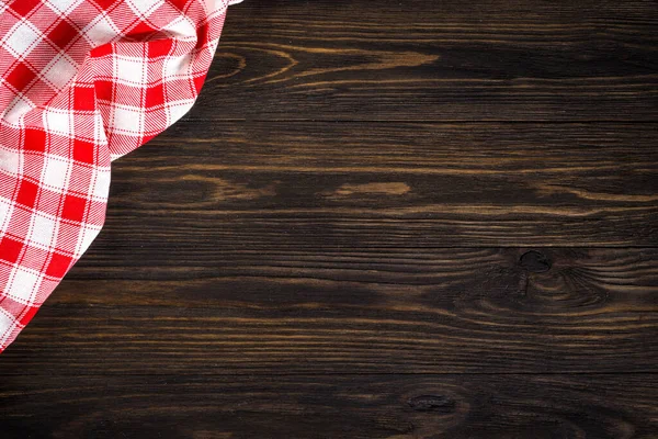 Kitchen table with red plaid tablecloth. — Stock Photo, Image