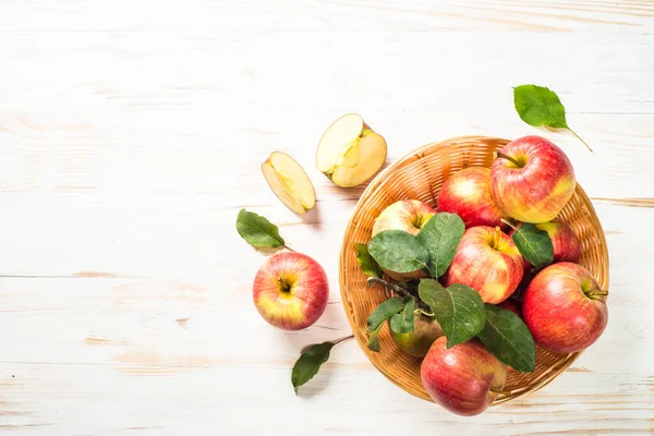 Fresh ripe red apples in the basket at white table. — Stock Photo, Image