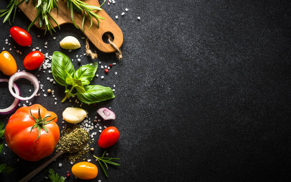 Food cooking background on black stone table.