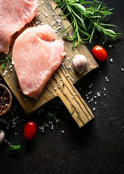 Türkiye, siyah taş masadaki ahşap tahtada baharat ve otlarla biftek yiyor.