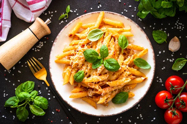 Italian pasta with tomato sauce, basil and parmesan cheese on dark table. — Stok fotoğraf