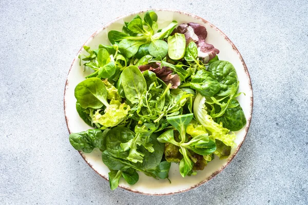Green salad, Fresh salad leaves and vegetables in white plate. — Stockfoto