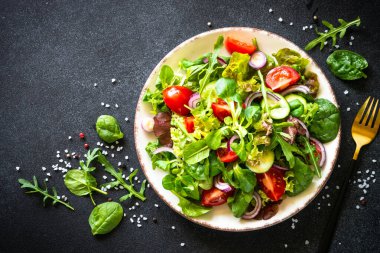 Green salad, Fresh salad leaves and vegetables in white plate.