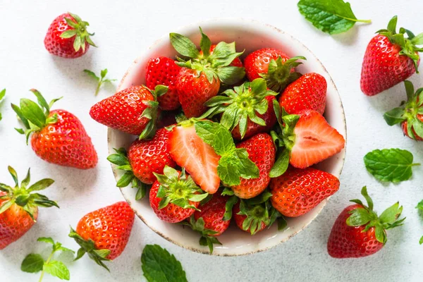 Fresh ripe strawberry in the bowl at white table. — Stock Photo, Image