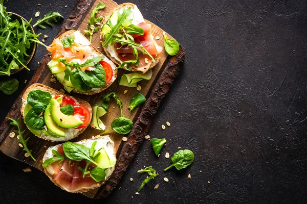 Open Sandwiches Set Cream Cheese Prosciutto Salmon Avocado Fresh Greens — Stockfoto