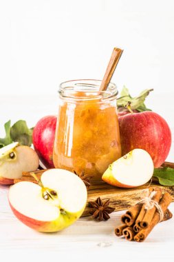 Baharatlı elma reçeli ve beyaz arkaplanda taze elma.