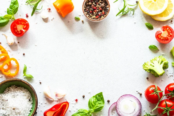 Food frame with Fresh vegetables, herbs and spices on white background. Top view with copy space.