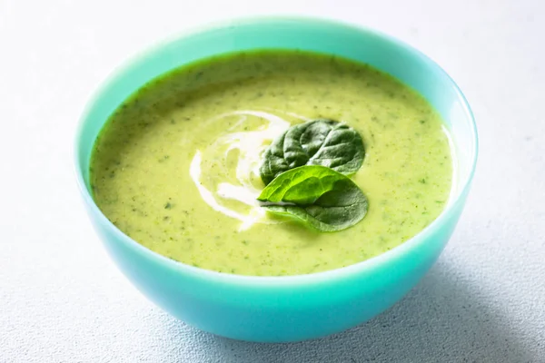 Green soup. Spinach cream soup with cream. Healthy vegan dish. Close up.