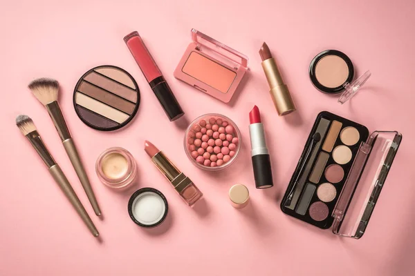 Beauty products. Make up products at pink background. Eye shadow, powder, lipstick for professional make up.