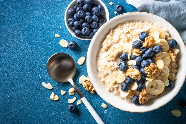 Healthy Breakfast Oatmeal Porrige Berries Nuts Blue Background Top View — 스톡 사진