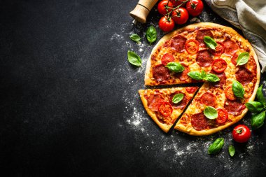 Salam peynirli pizza, domates ve fesleğen. Kopyalama alanı olan üst görünüm, makro.