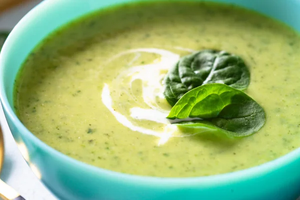 Green soup. Spinach cream soup with cream. Healthy vegan dish. Close up.