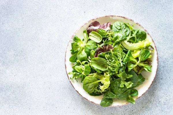 Green Salad Leaves White Plate Light Background Top View Image — Stockfoto