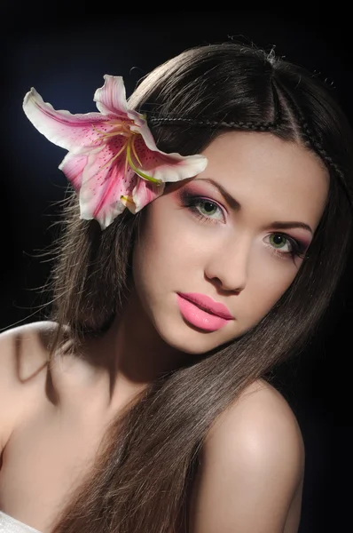 Beauty with orchid in a dark — Stock Photo, Image