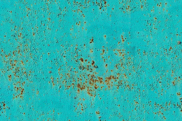 Old bright blue painted rusty stone wall, seamless tiling texture