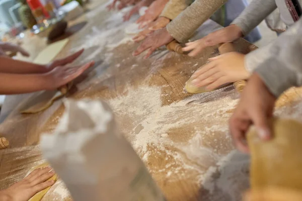 Blurred photo of people cooking cake at cooking classes