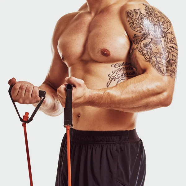 Closeup Strong Muscular Athletic Bodybuilder Tattoo Biceps Training Expander — Stockfoto