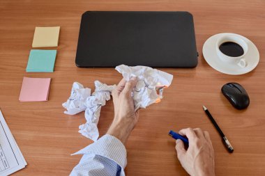 Closeup of tired manager setting fire to waste paper