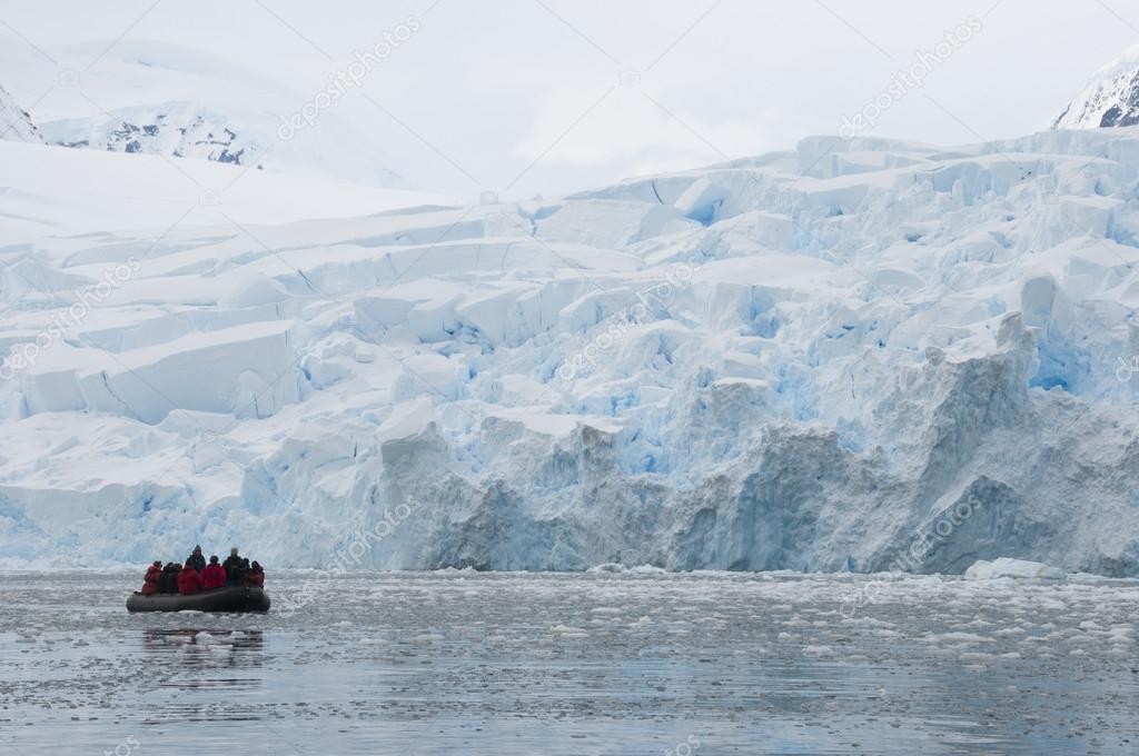 Boat in front of snow mountains in Antarctic