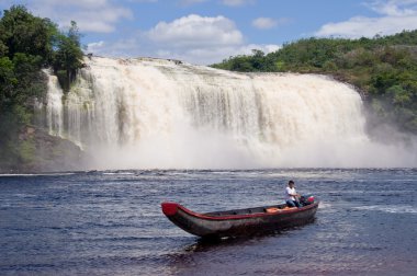 Waterfall and boat in Canaima National Park, Venezuela clipart