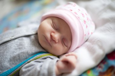 Little baby sleeping on a cot. clipart