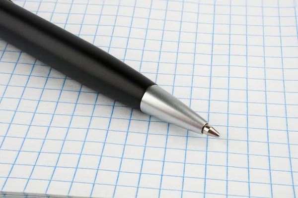 Black ballpoint pen on notebook sheet