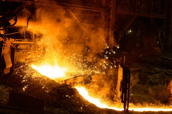 Blast furnace, cast iron production. Metal poured out of the metallurgical furnace