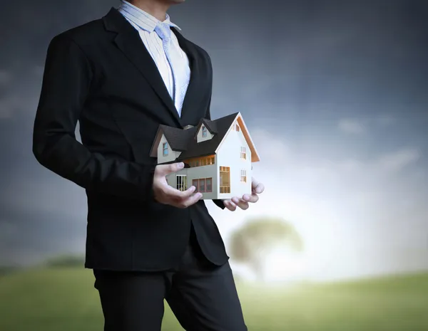 House in human hands — Stock Photo, Image