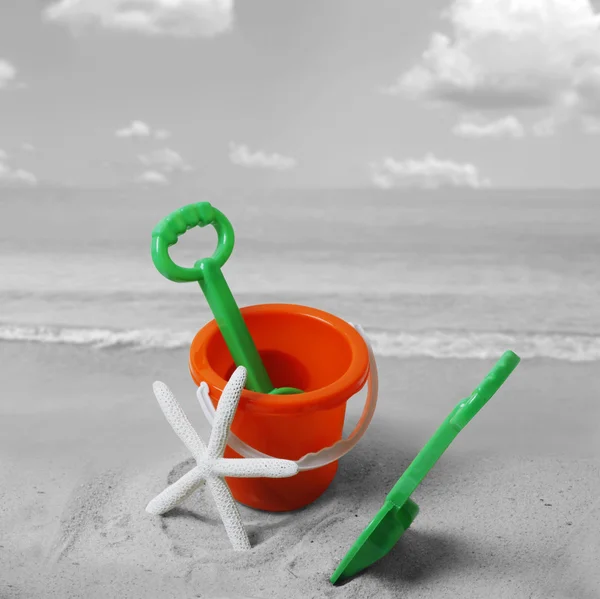 Spade and bucket on beach — Stock Photo, Image