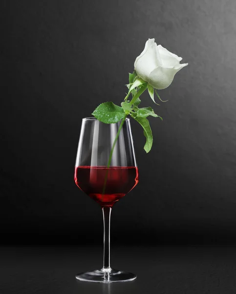 Glas rött vin och rosor — Stockfoto
