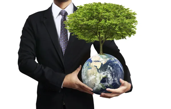 Holding a glowing earth (NASA) globe and tree in his hand — Stock Photo, Image