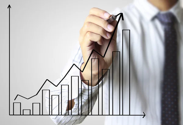 Business man hand drawing graph — Zdjęcie stockowe