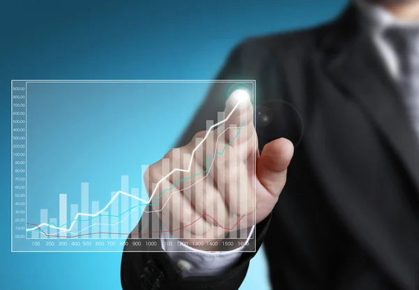 Business man pointing at growth graph — Stock Photo, Image