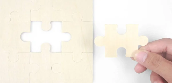 Connecting jigsaw puzzle in a hand. Business solutions success and strategy concept